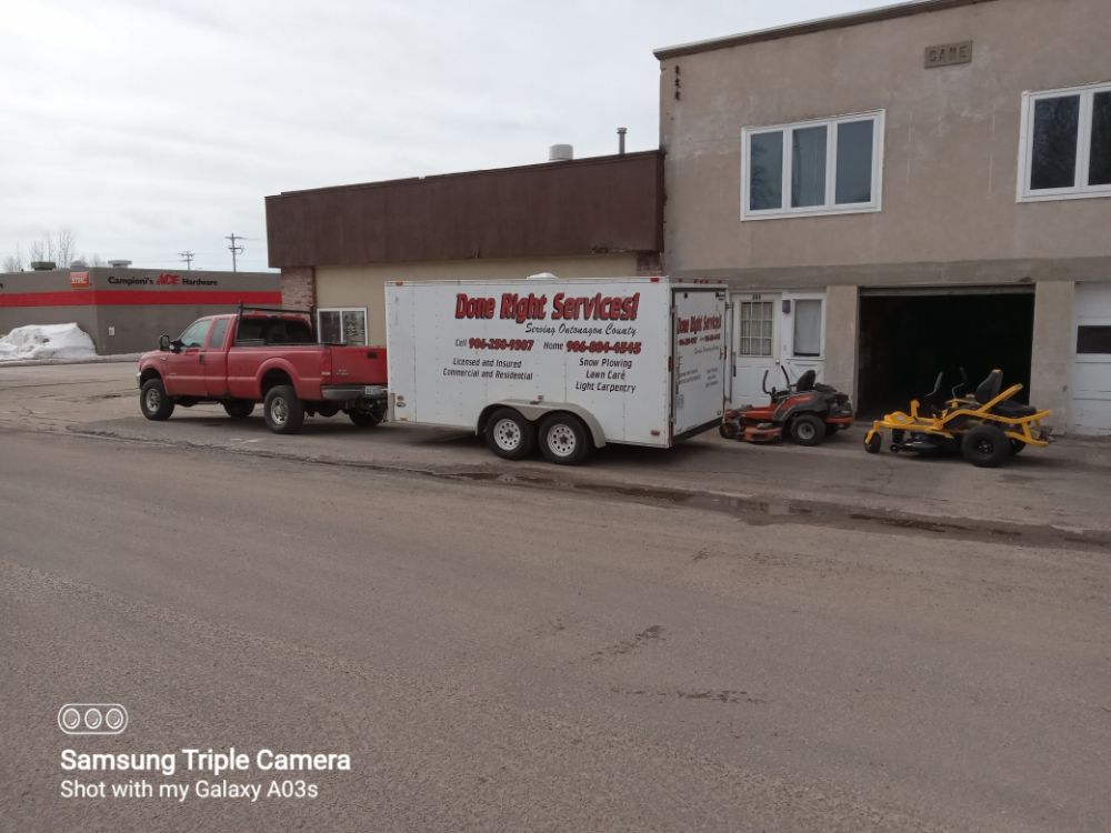 Done Rite Services red work truck, enclosed equipment trailer, and commercial lawn mowers